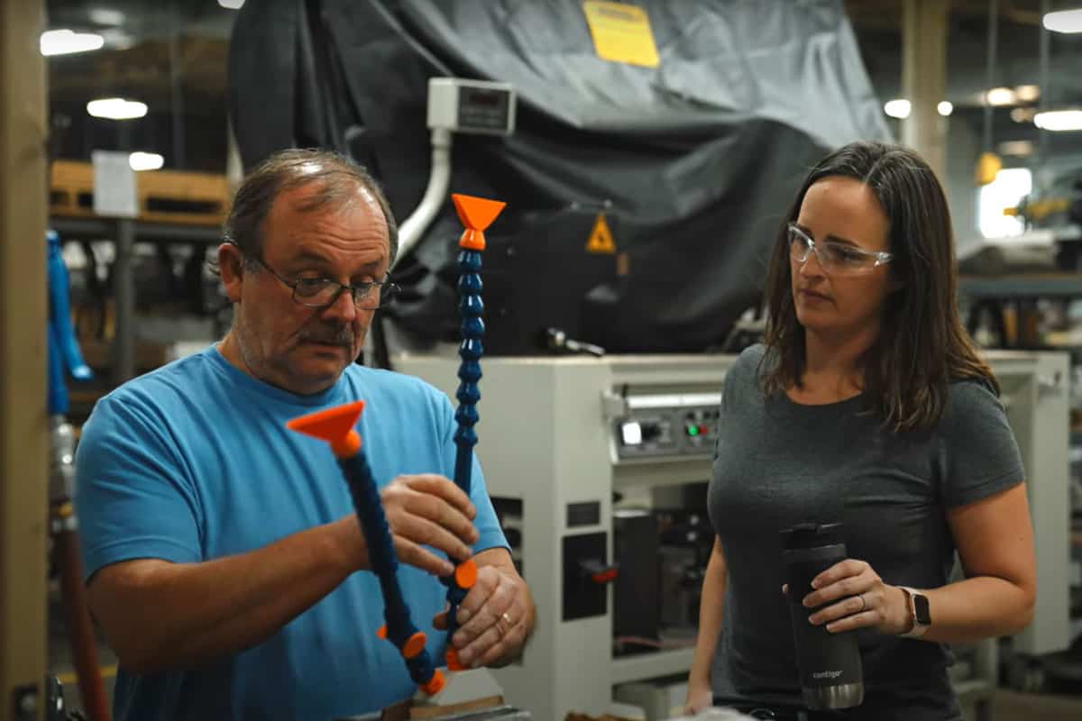 Dcm Tech Employees Adjusting A Machine